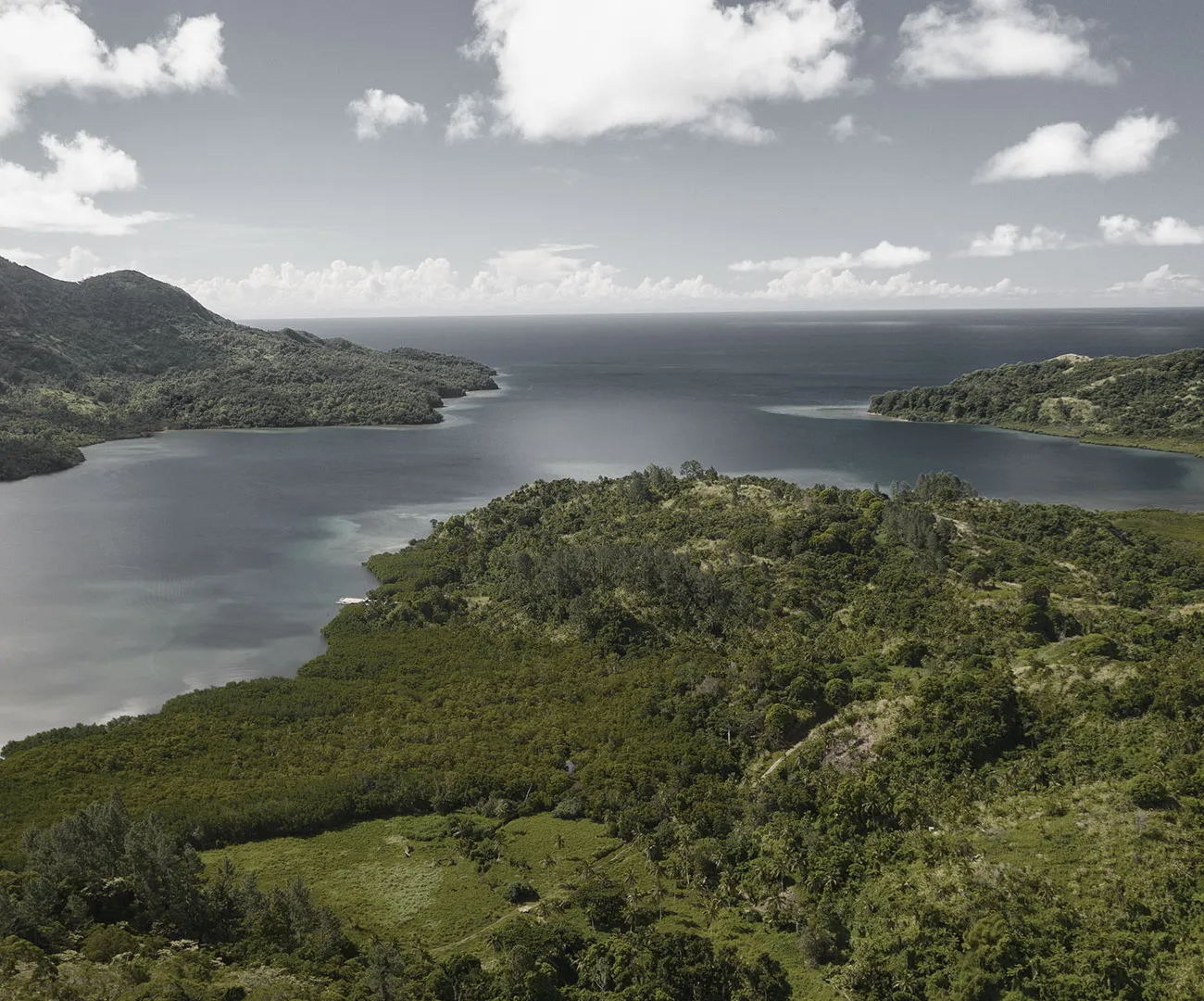 Green Fijian islands under a dramatic South Pacific sky